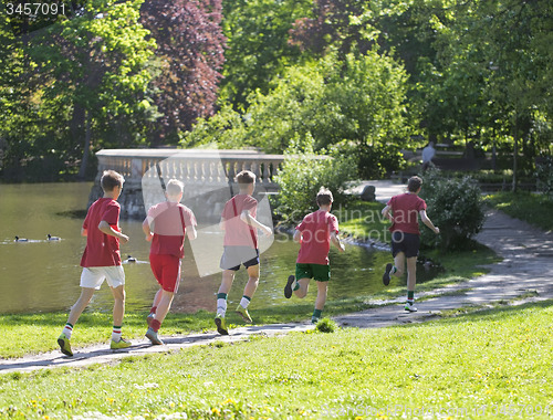 Image of Young boys run in park