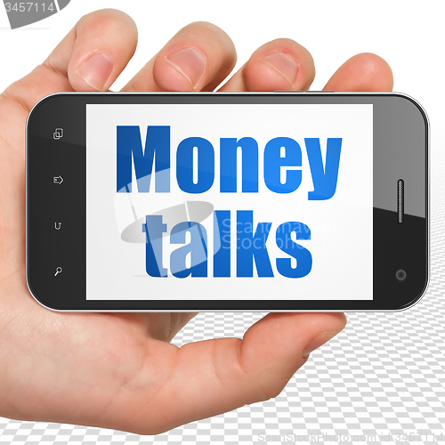 Image of Finance concept: Hand Holding Smartphone with Money Talks on display