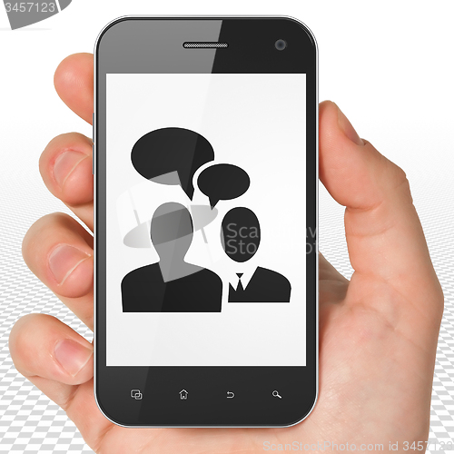 Image of Business concept: Hand Holding Smartphone with Business Meeting on display