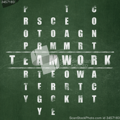 Image of Finance concept: word Teamwork in solving Crossword Puzzle