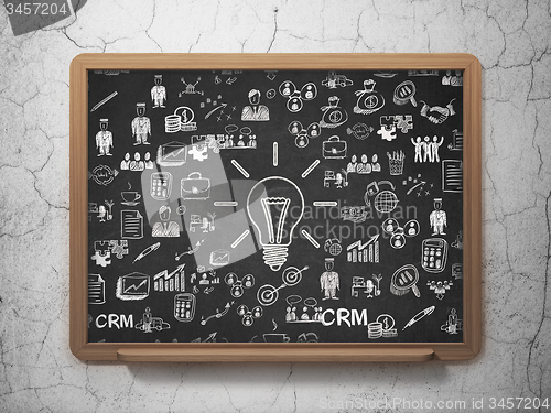 Image of Finance concept: Light Bulb on School Board background