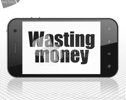 Image of Money concept: Smartphone with Wasting Money on display