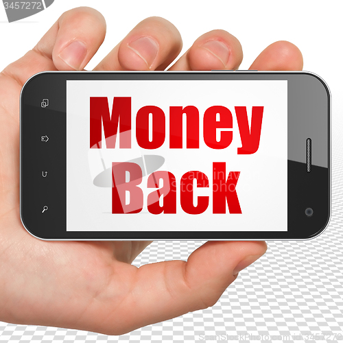 Image of Business concept: Hand Holding Smartphone with Money Back on display