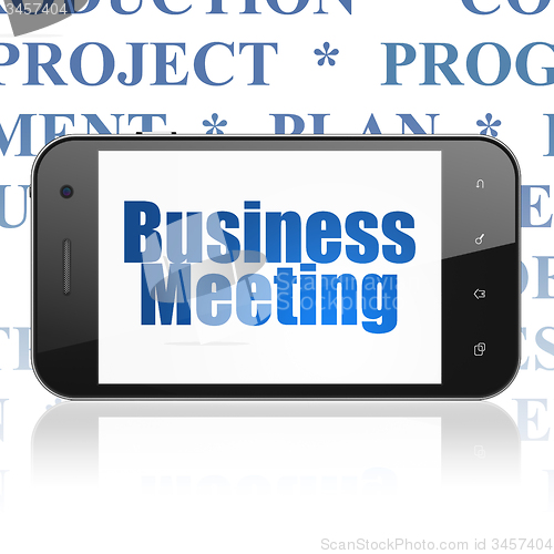 Image of Finance concept: Smartphone with Business Meeting on display