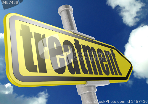Image of Yellow road sign with treatment word under blue sky