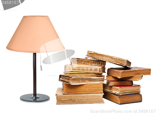 Image of old books with a lamp