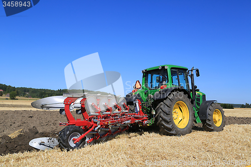 Image of John Deere 6630 Tractor and Agrolux Plow Plowing the Field 