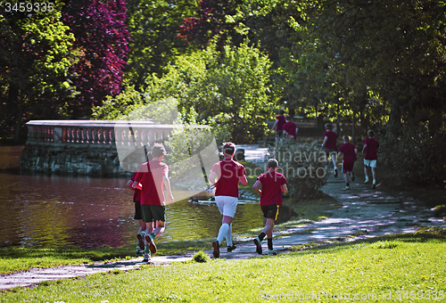 Image of Young boys run in park