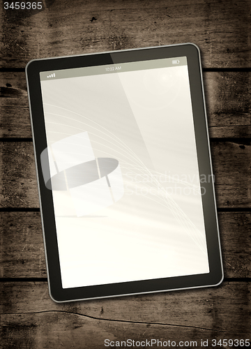 Image of Digital tablet PC on a dark wood table