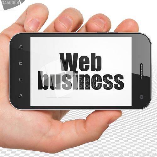 Image of Web development concept: Hand Holding Smartphone with Web Business on display