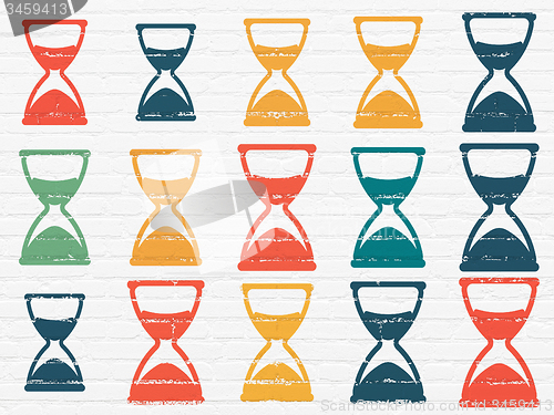 Image of Time concept: Hourglass icons on wall background