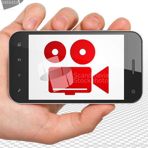 Image of Tourism concept: Hand Holding Smartphone with Camera on display
