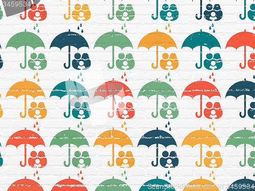 Image of Insurance concept: Umbrella icons on wall background