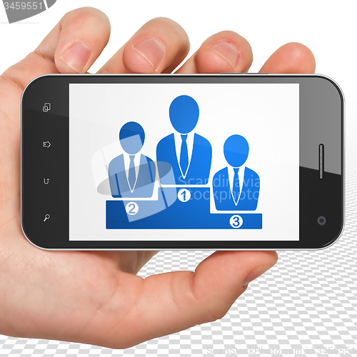 Image of Law concept: Hand Holding Smartphone with Business Team on display