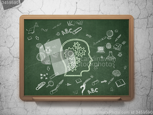 Image of Education concept: Head With Gears on School Board background