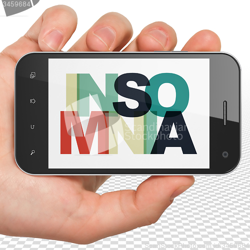 Image of Healthcare concept: Hand Holding Smartphone with Insomnia on  display