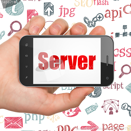 Image of Web design concept: Hand Holding Smartphone with Server on display