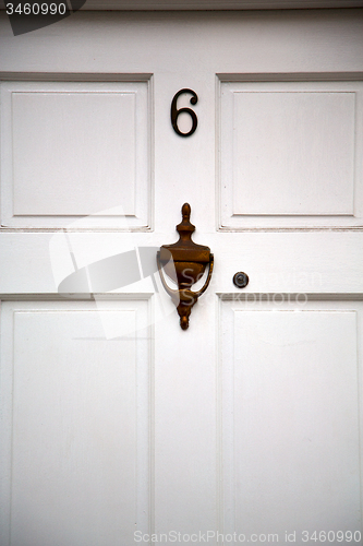 Image of handle in london antique brown door    nail and light