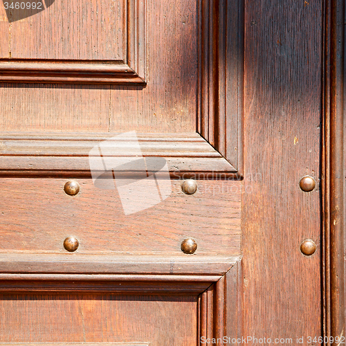 Image of door in italy old ancian wood and trasditional  texture nail