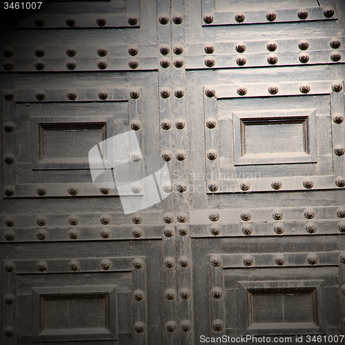 Image of handle in london antique brown door  rusty  brass nail and light