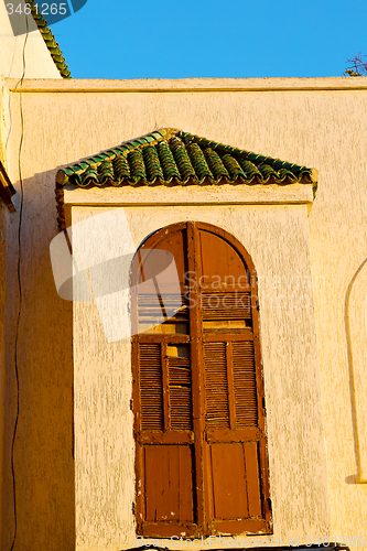 Image of   yellow window in   old construction and wall  