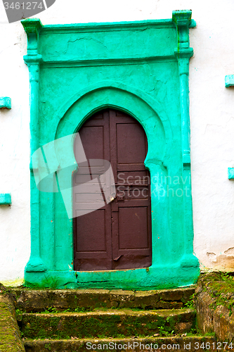 Image of old door in morocco  and wall ornate green