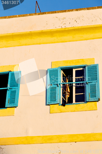 Image of blue window in morocco  brown wall  construction