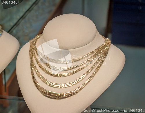 Image of Beautiful jewelry - gold necklace on the mannequin.