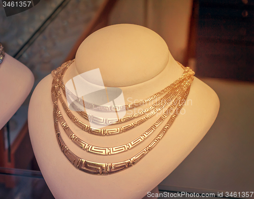 Image of Beautiful jewelry - gold necklace on the mannequin.