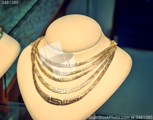 Image of Beautiful jewelry - gold necklace on the mannequin.