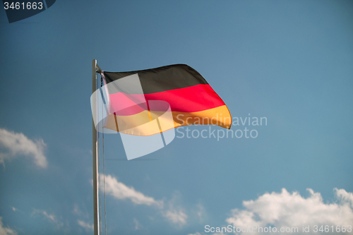 Image of Germany flag in front of a blue sky