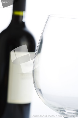 Image of Glass and red wine bottle