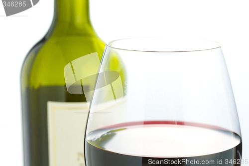 Image of Glass and red wine bottle