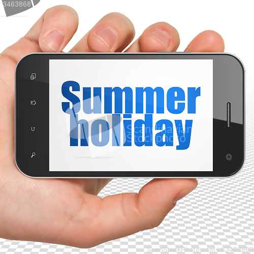 Image of Travel concept: Hand Holding Smartphone with Summer Holiday on display