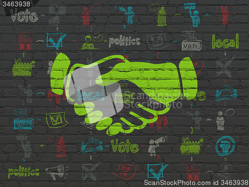 Image of Political concept: Handshake on wall background