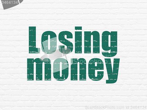 Image of Currency concept: Losing Money on wall background