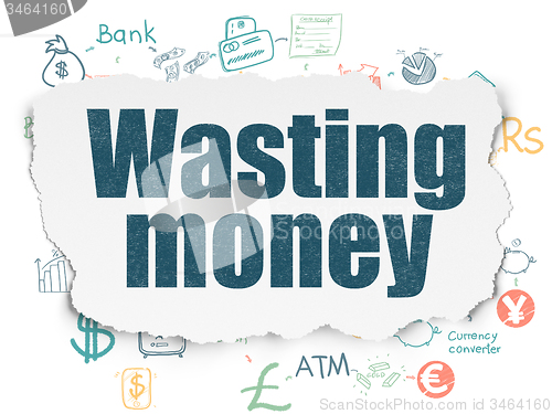 Image of Banking concept: Wasting Money on Torn Paper background