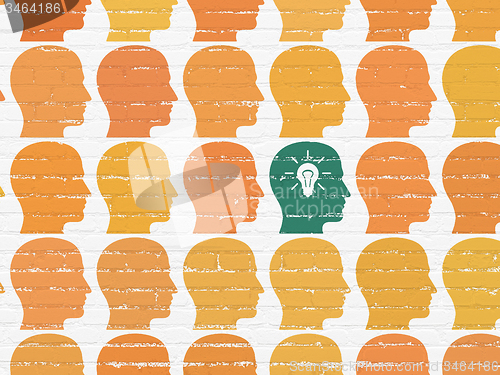 Image of Finance concept: head with light bulb icon on wall background