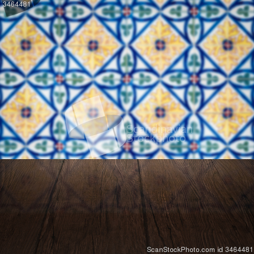 Image of Wood table top and blur vintage ceramic tile pattern wall