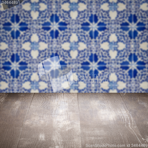 Image of Wood table top and blur vintage ceramic tile pattern wall