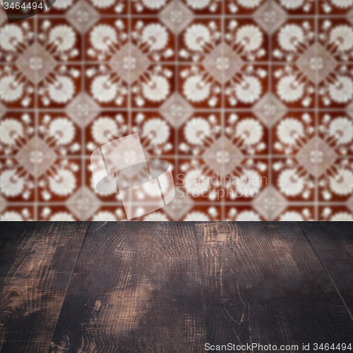 Image of Wood table top and blur vintage ceramic tile pattern wall