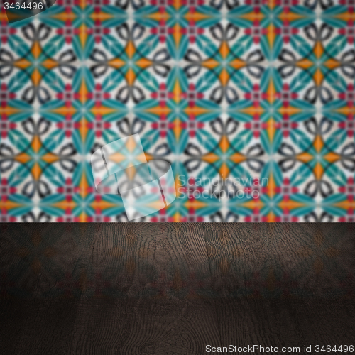 Image of Wood table top and blur vintage ceramic tile pattern wall