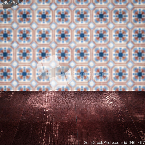 Image of Wood table top and blur vintage ceramic tile pattern wall