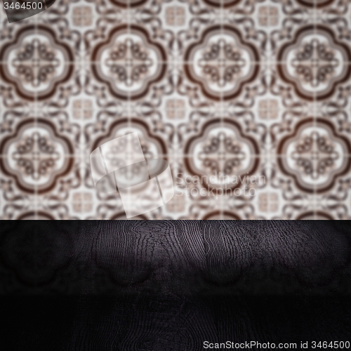 Image of Wood table top and blur vintage ceramic tile pattern wall