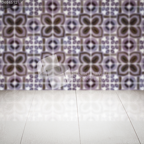 Image of Wood table top and blur vintage ceramic tile pattern wall