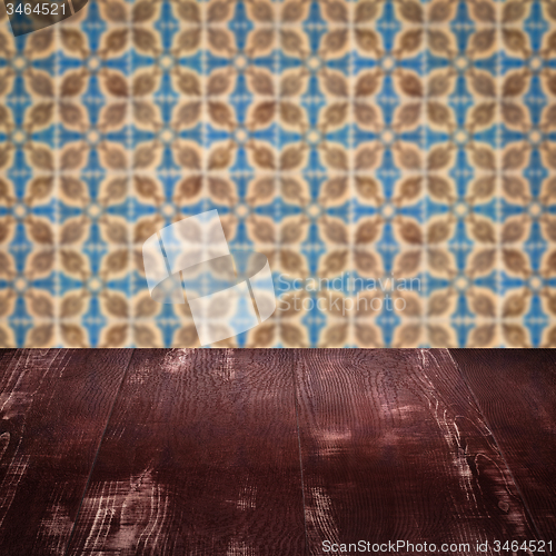 Image of Wood table top and blur vintage ceramic tile pattern wall