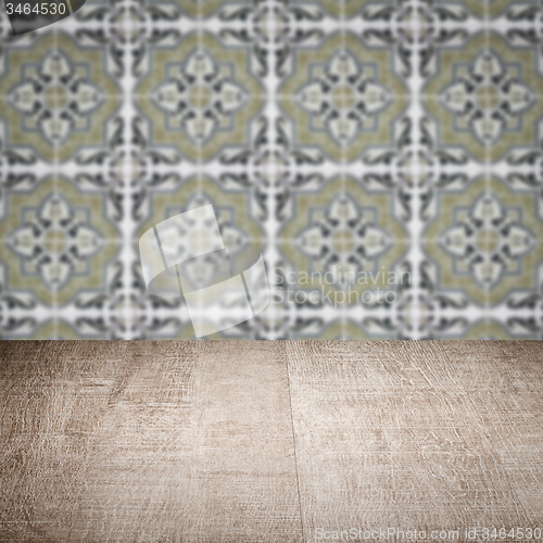 Image of Wood table top and blur vintage ceramic tile pattern wall