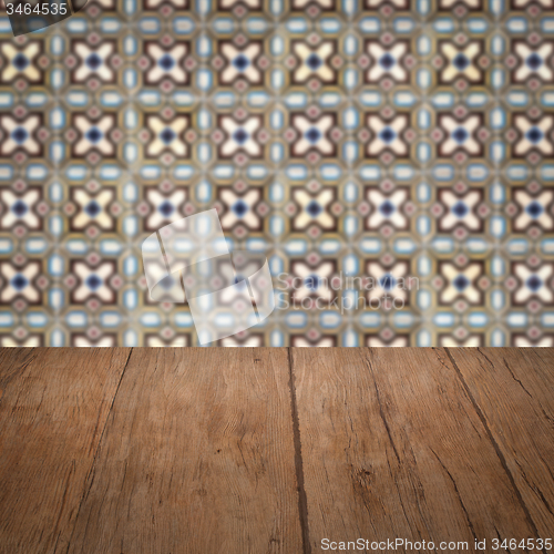 Image of Wood table top and blur vintage ceramic tile pattern wall