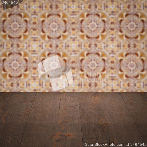 Image of Wood table top and blur vintage ceramic tile pattern wall