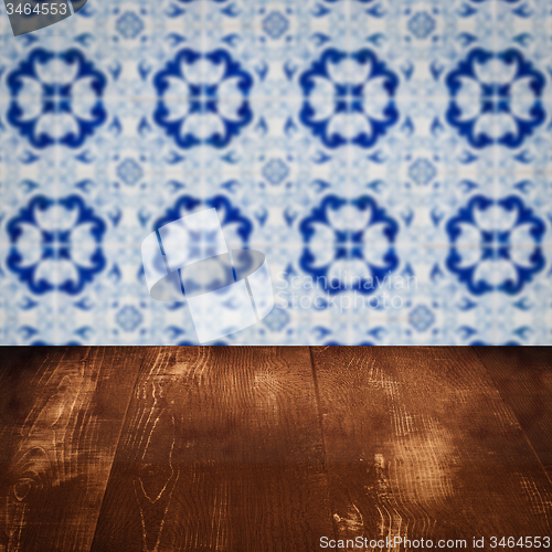 Image of Wood table top and blur vintage ceramic tile pattern wall